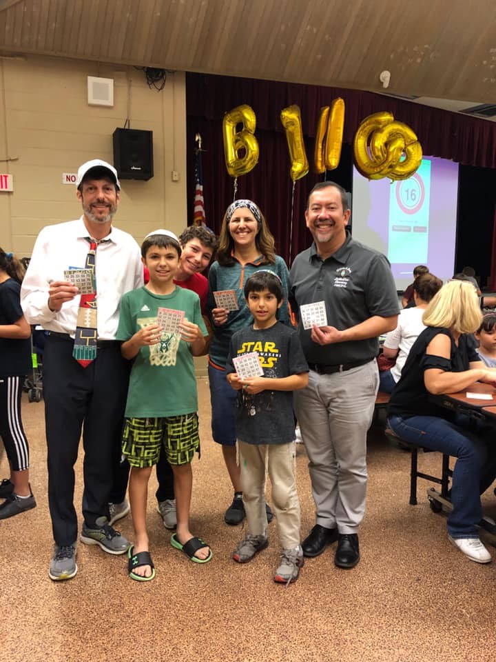 Martin Karp, his wife Danielle and sons Herschel, Benjamin and Samson attend a Virginia A. Boone Highland Oaks Elementary (VABHOE) School PTSA fundraiser with Principal Julio Fong.